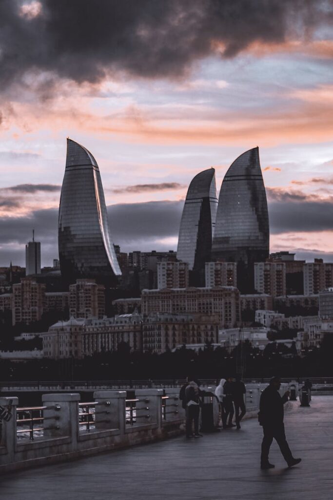 pexels photo 14116763 14116763 Breathtaking view of Baku's Flame Towers skyline at sunset with a vibrant pedestrian scene.